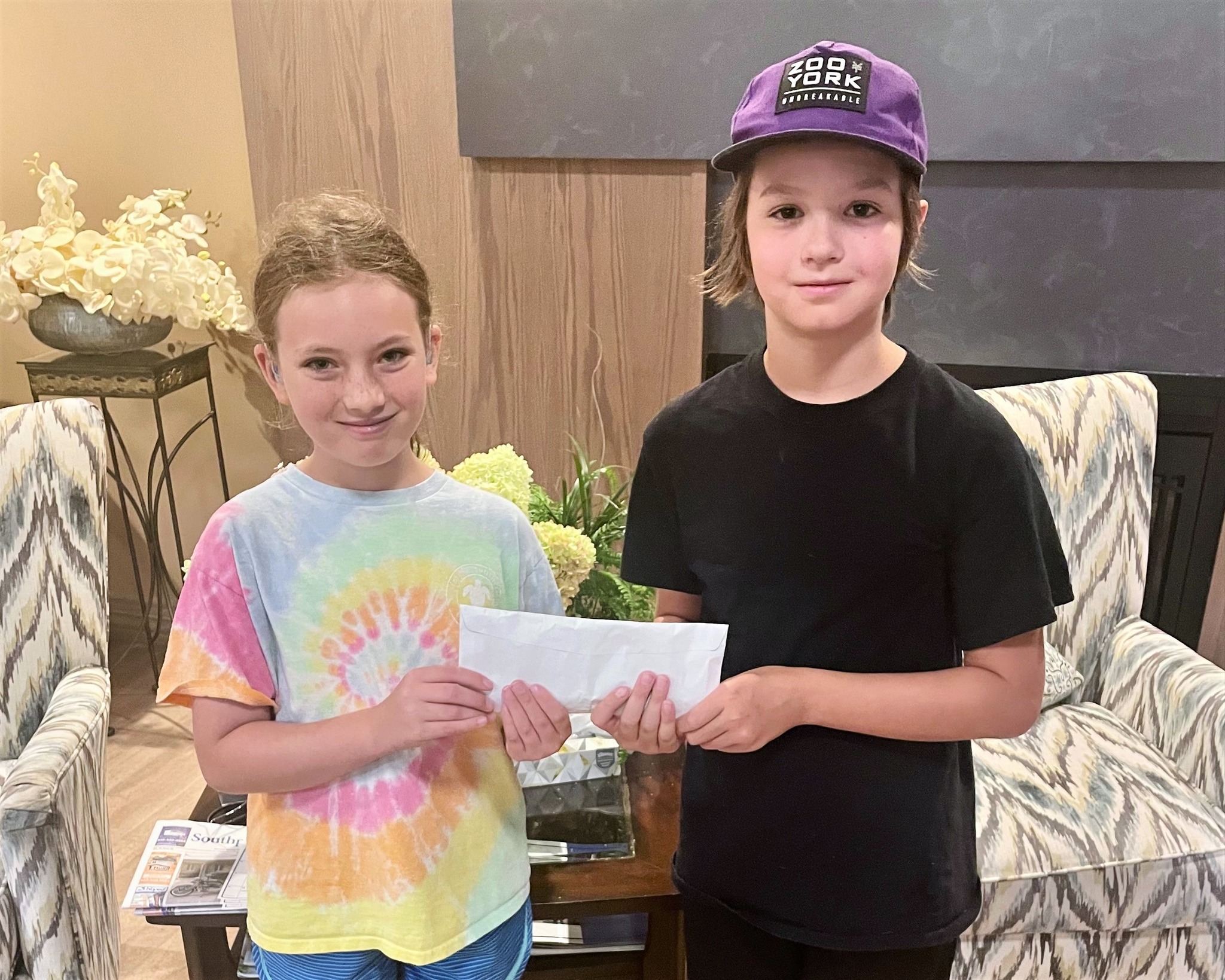 Ben and Mikayla Donate $200 to Hogs for Hospice from Selling Water During Hogs for Hospice Weekend